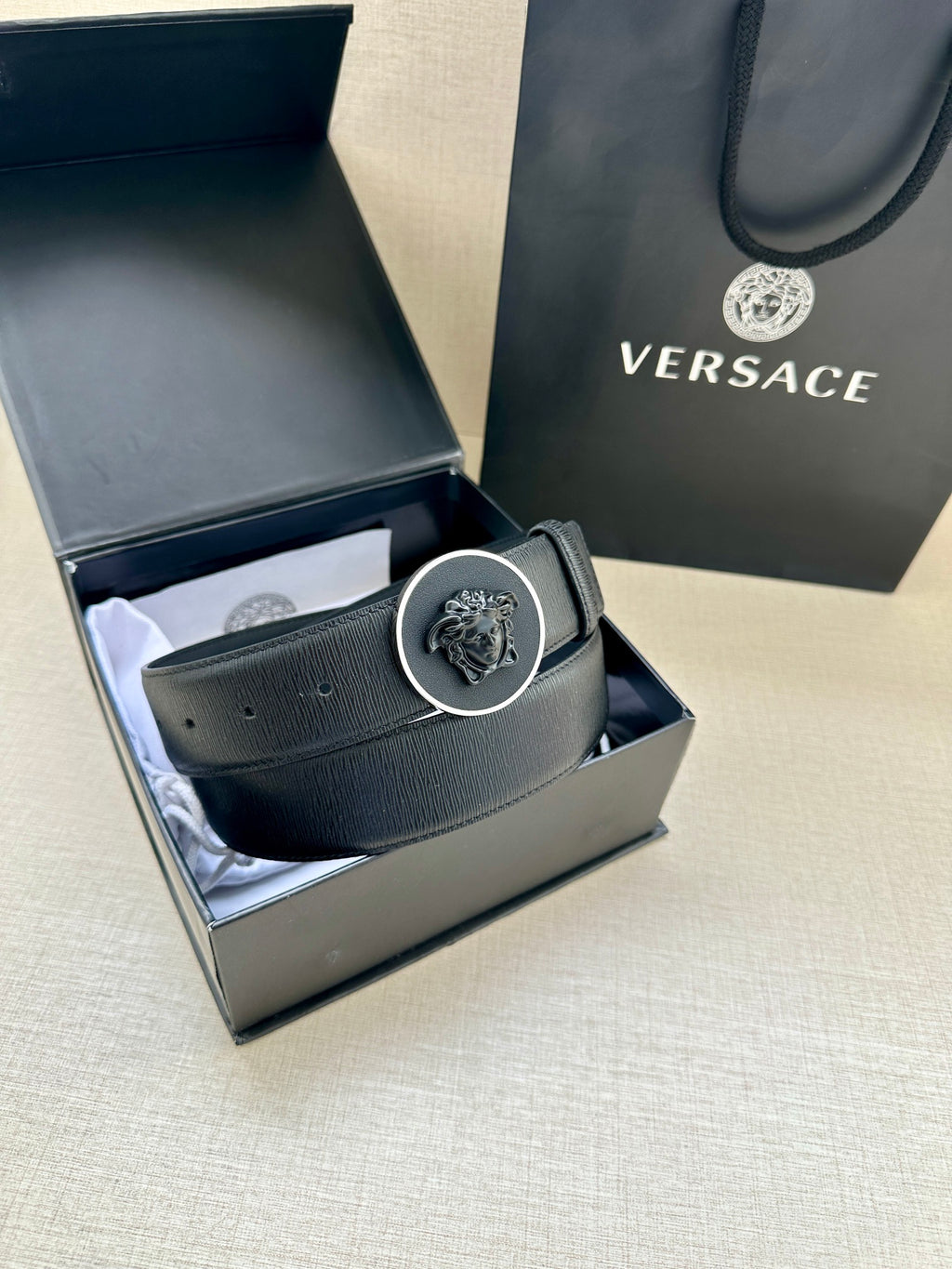 Versace belt in box with dark blue leather strap and round emblem buckle