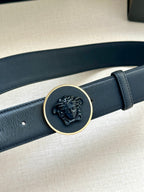 Versace belt with gold-tone circular emblem buckle on dark blue strap