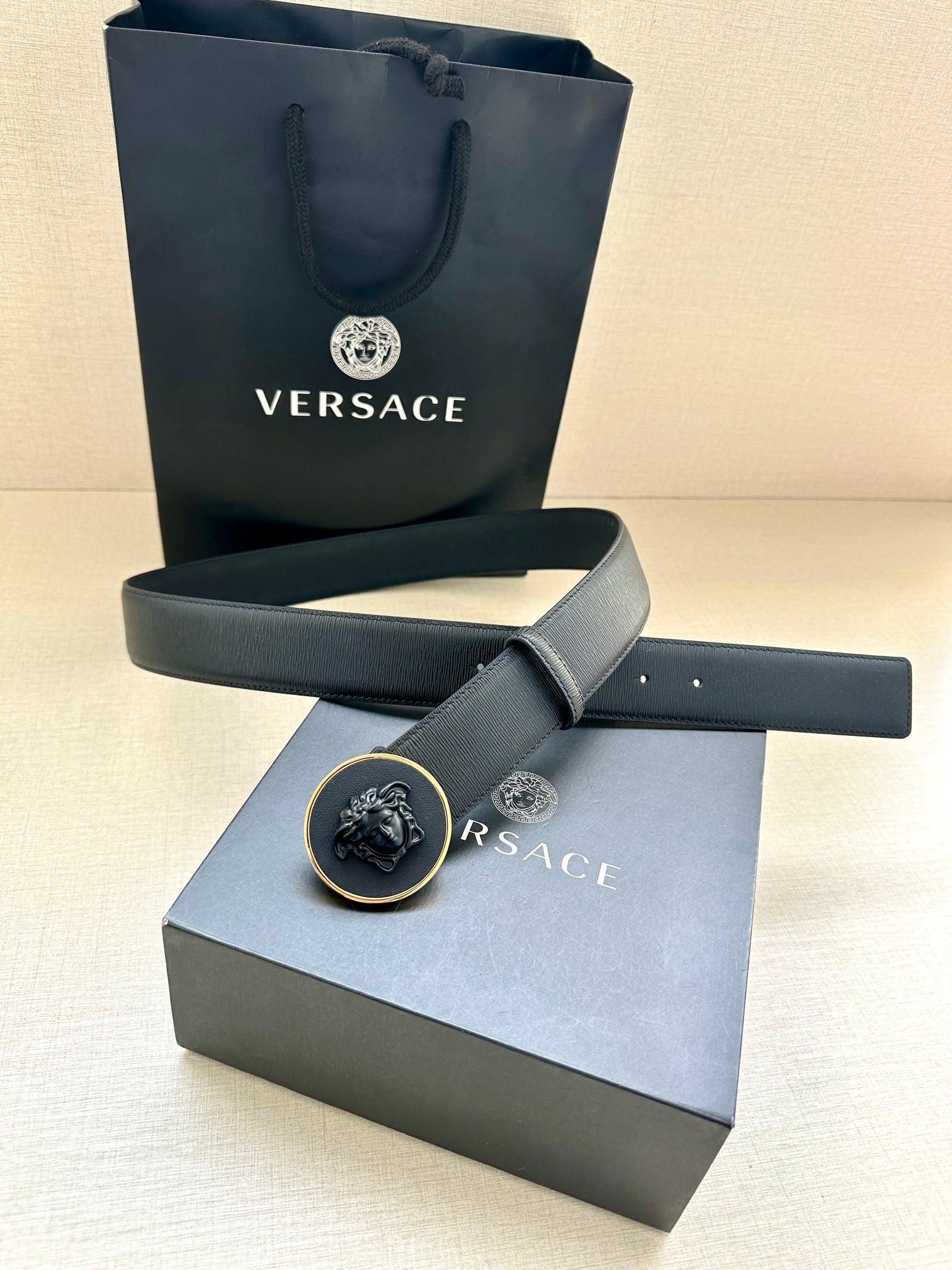 Versace belt with gold-tone round emblem buckle and dark blue strap