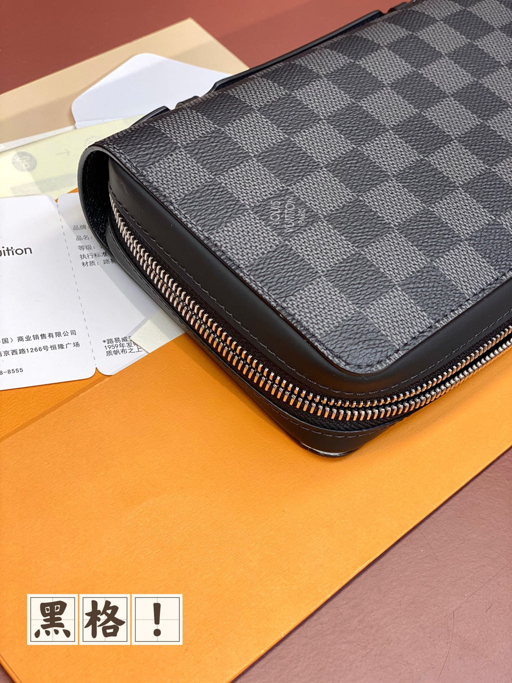 Louis Vuitton small bag with dark blue check cover, silver-tone zipper and side profile