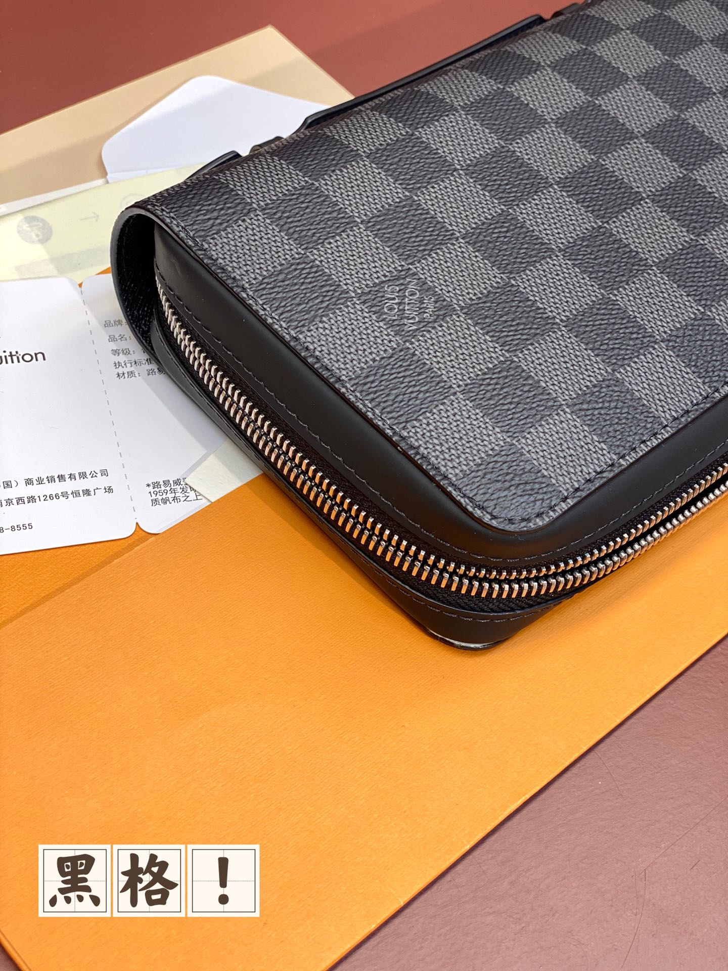 Louis Vuitton small bag with dark blue check cover, silver-tone zipper and side profile