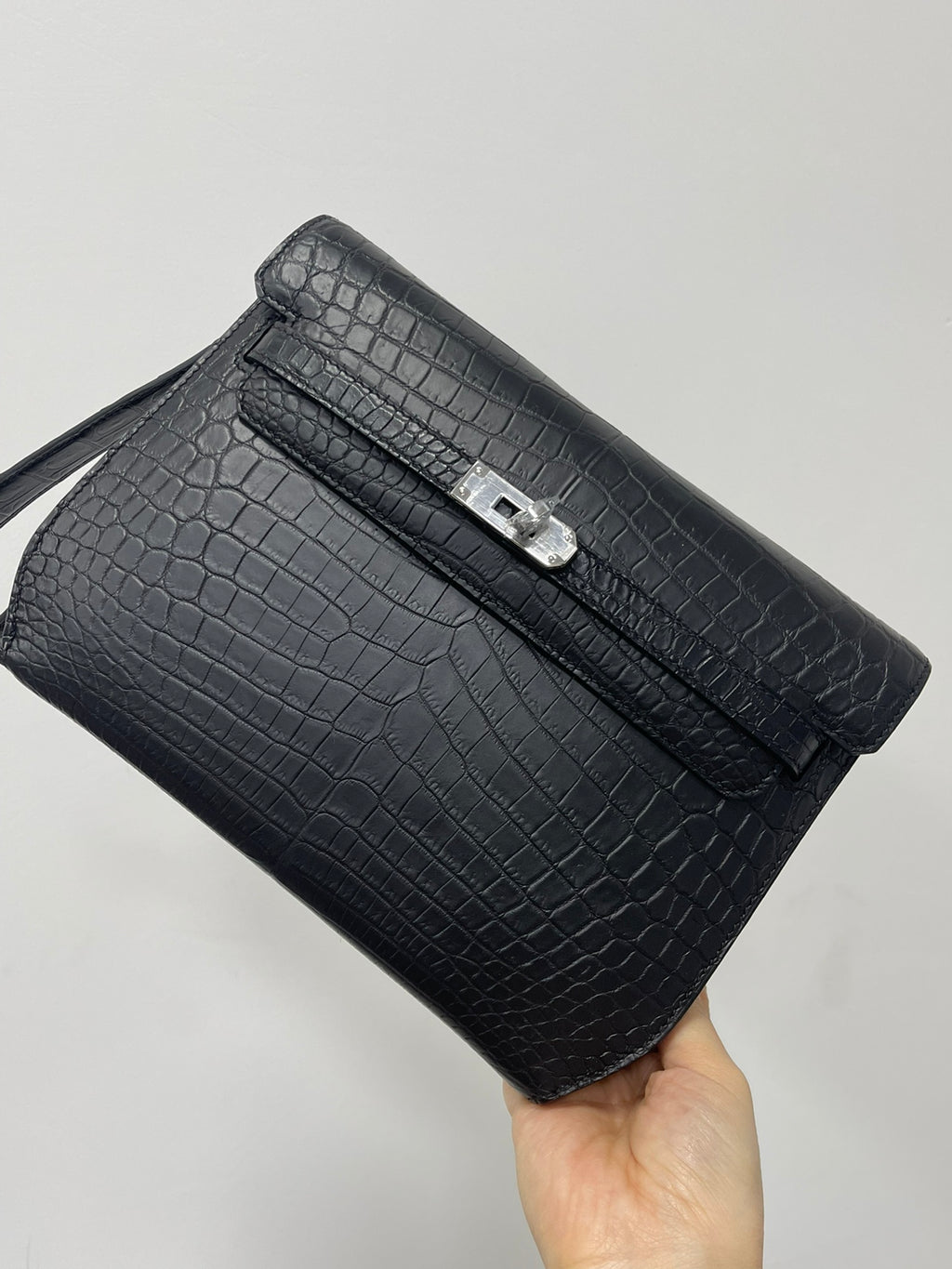 Hermes bag in dark croc-embossed leather, front flap with silver lock and strap