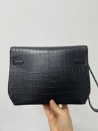 Hermes bag with front fold-over flap and two curved corner pockets, dark leather