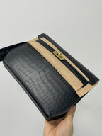 Hermes bag, croc-textured dark flap with gold hardware, beige stripe trim, wrist strap