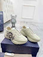 Gucci unisex luxury sneakers pair, cream lace-up with GG emblem on side