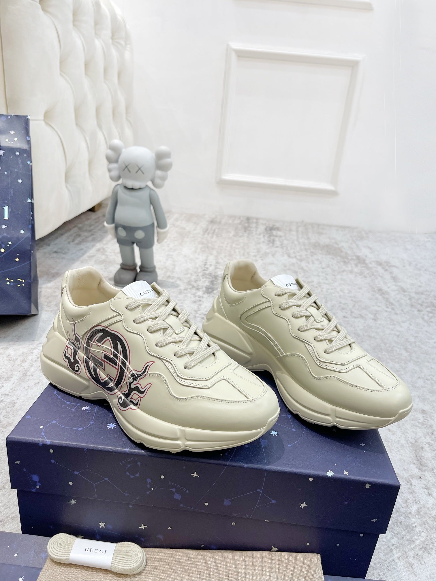 Gucci unisex luxury sneakers pair, cream lace-up with GG emblem on side