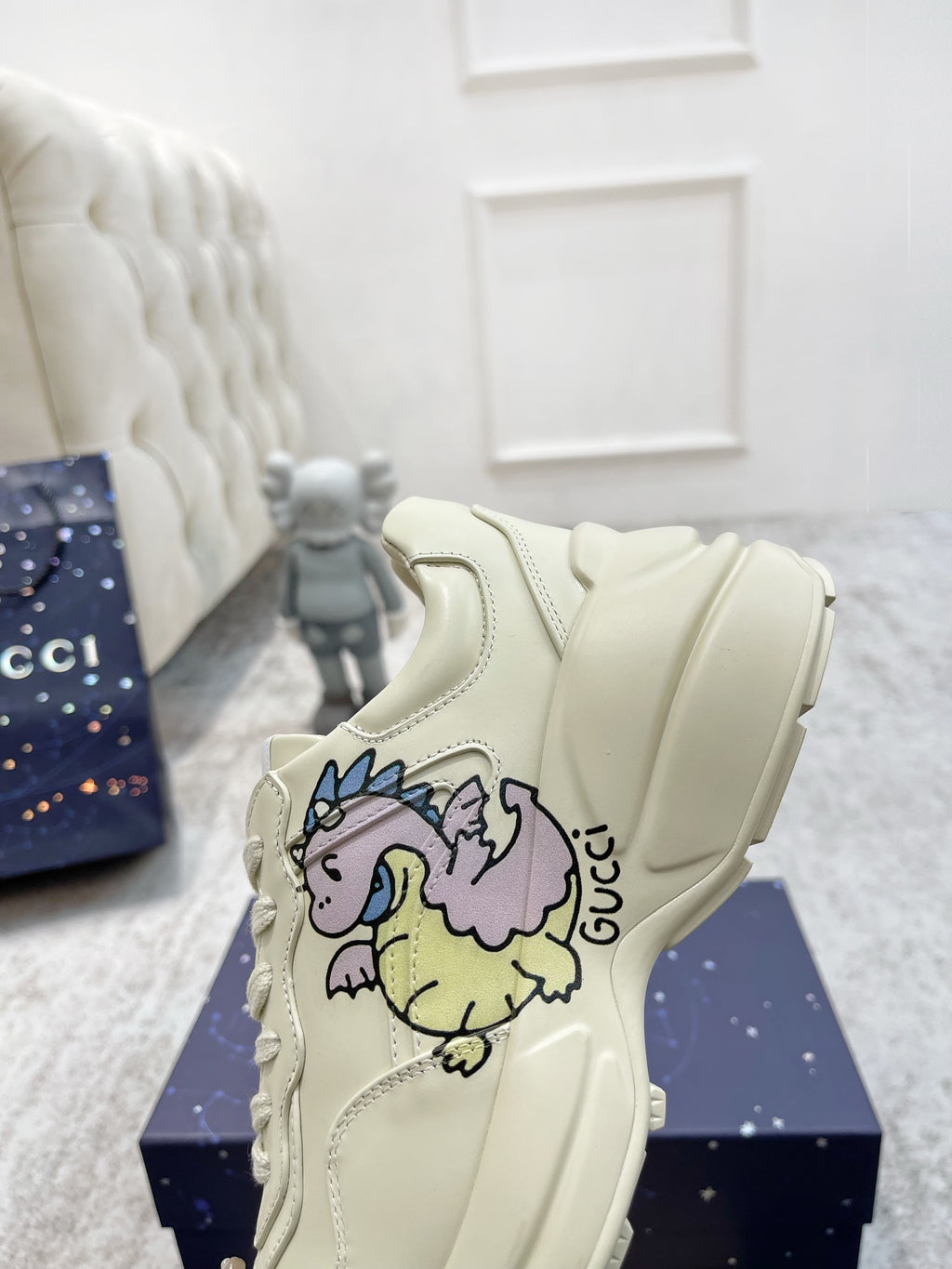 Gucci unisex luxury shoes: cream lace-up sneaker with large unicorn graphic on side