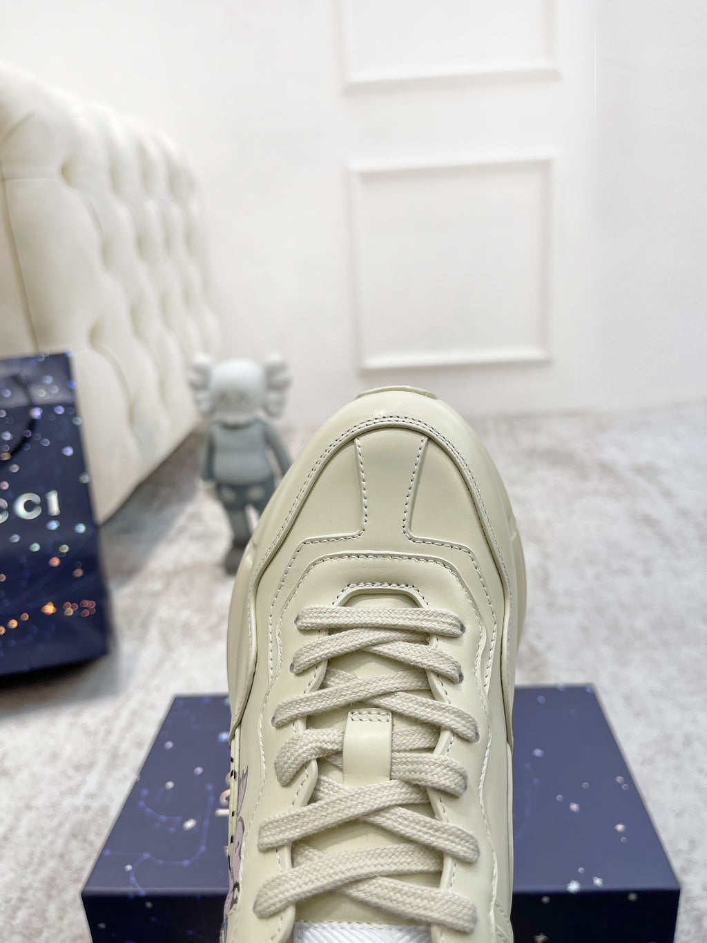 Gucci unisex luxury shoes: cream sneaker front view with lace-up and padded collar