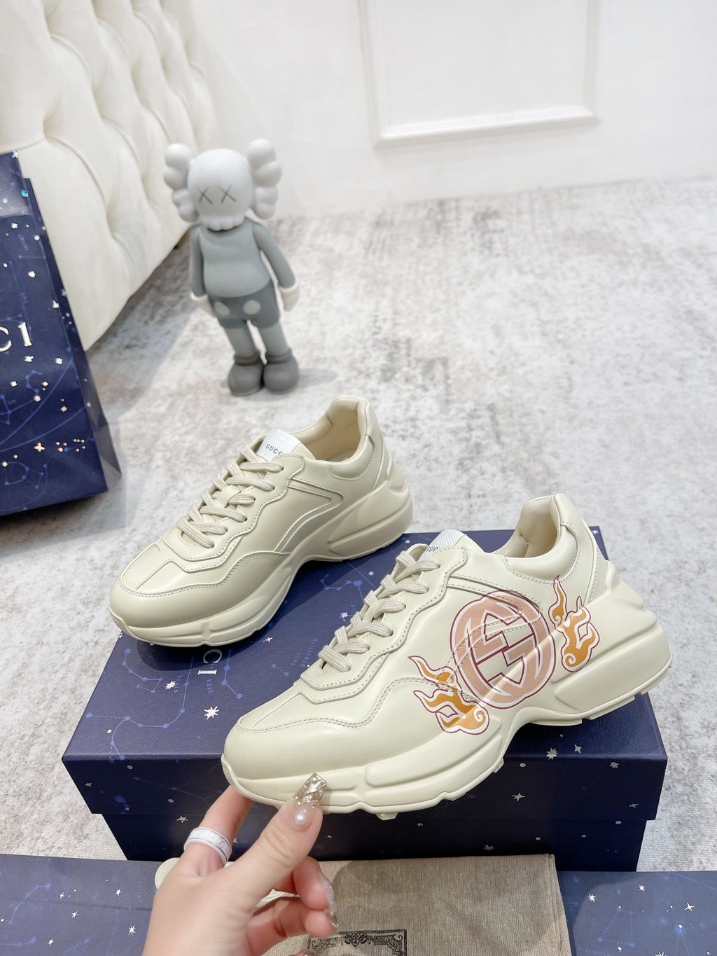 Gucci unisex luxury sneakers, light cream pair with crest emblem on the side