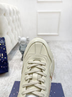 Gucci unisex luxury sneakers, light cream upper close-up with laces and stitching details