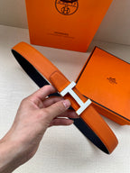 Hermes belt in orange textured leather with silver H buckle, single keeper strap