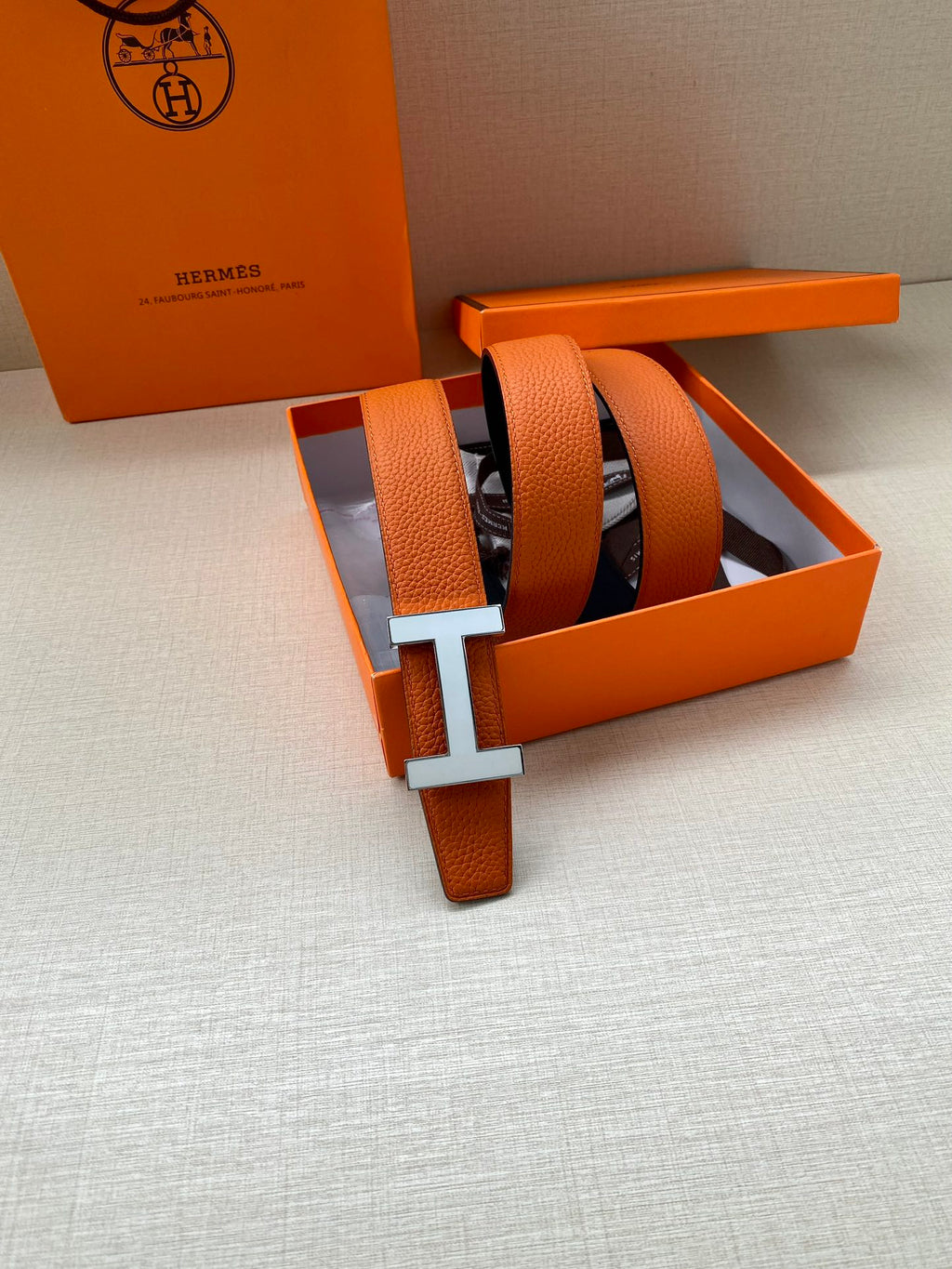 Hermes belt set: orange strap with silver H buckle and matching orange keeper
