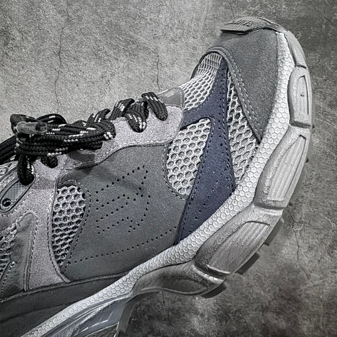 Gray athletic sneaker with suede overlays, mesh panels, and thick treaded sole