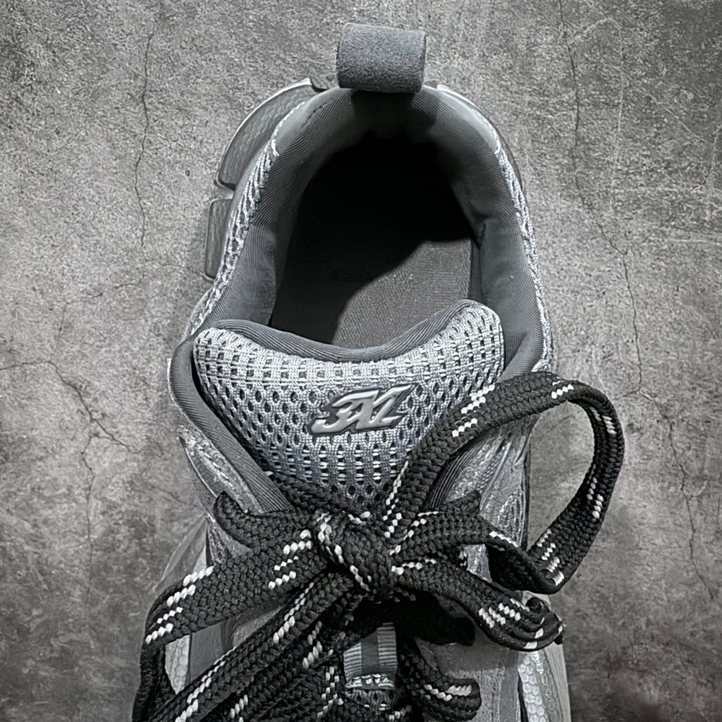 Sneaker interior view with knit mesh lining and black laces, gray tongue