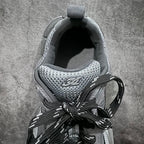 Sneaker interior view with knit mesh lining and black laces, gray tongue