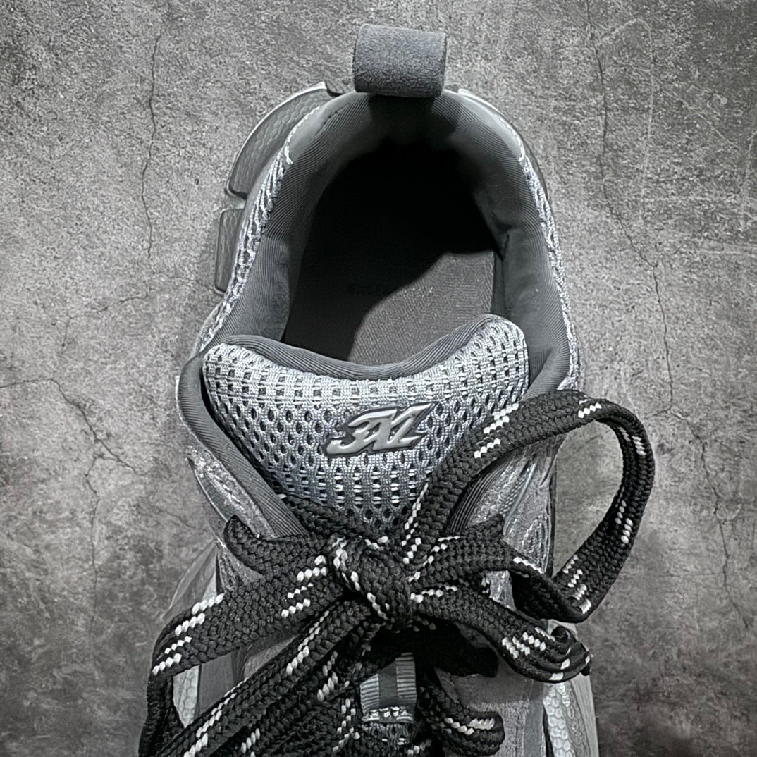 Sneaker interior view with knit mesh lining and black laces, gray tongue