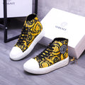 High-top sneakers with yellow floral print, black laces, and white rubber sole