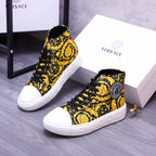 High-top sneakers with yellow floral print, black laces, and white rubber sole