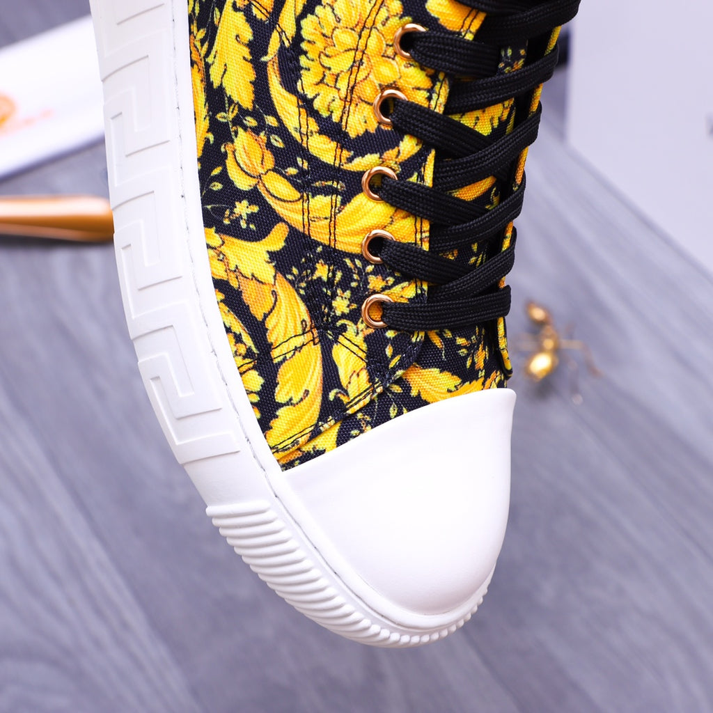 Front half of high-top sneakers: yellow floral textile, black laces, white sole