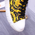 Front half of high-top sneakers: yellow floral textile, black laces, white sole