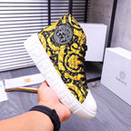 High-top sneakers with yellow floral pattern and round logo patch on the tongue