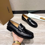 Burberry luxury loafers in black embossed leather, top view with metal bit detail