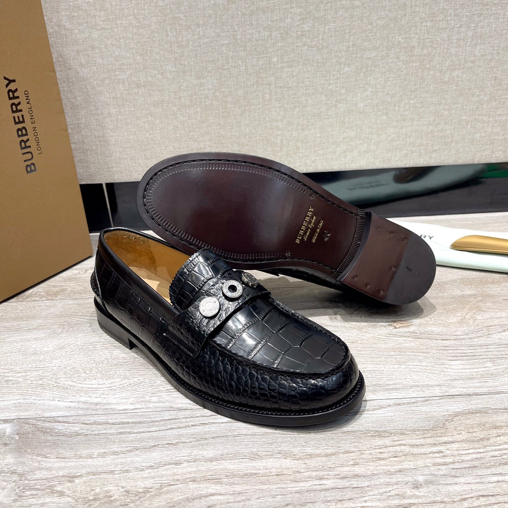 Burberry luxury loafers, black embossed leather, full sole underside view