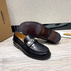 Burberry luxury loafers, black embossed leather, full sole underside view
