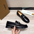Burberry luxury loafers, black embossed leather, low-profile sole and vamp hardware