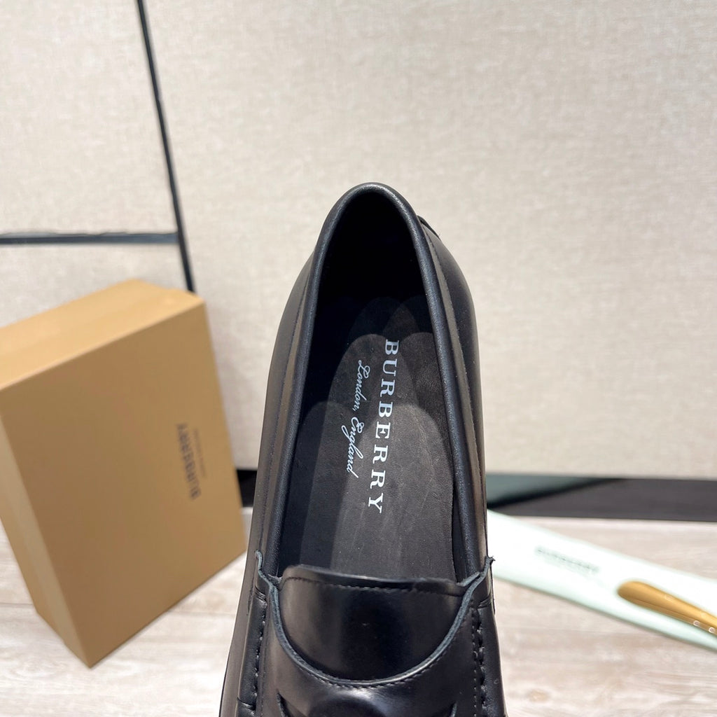 Black leather loafer with logo lining, front view showing stitched collar