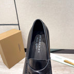 Black leather loafer with logo lining, front view showing stitched collar