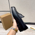 Black leather loafer with strap across vamp, side view, stitched edges
