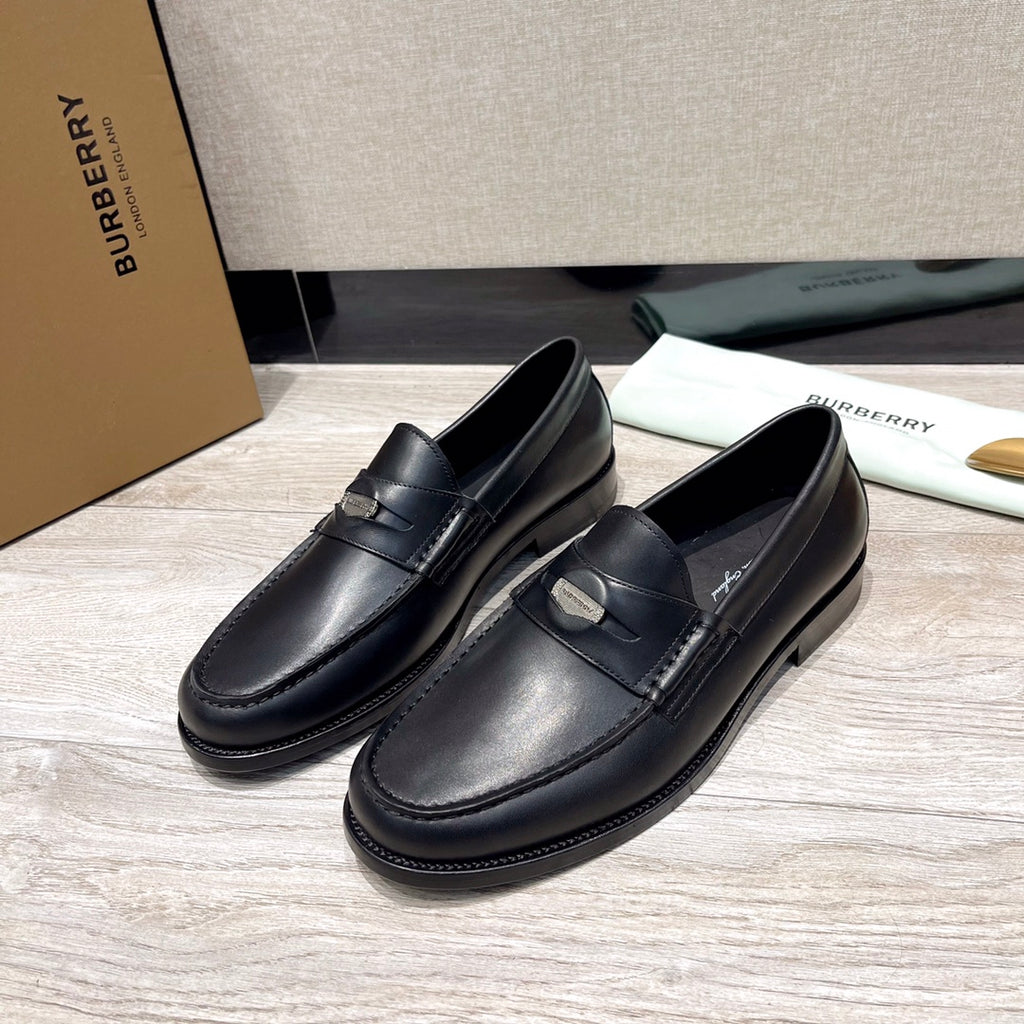 Black leather loafers with buckle detail and stitched apron, rounded toe