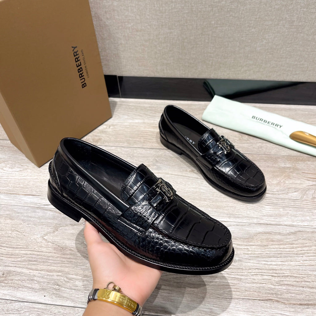 Black embossed leather loafers with metal buckle detail, pair