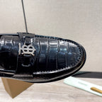 Black embossed leather loafer with metal buckle detail and stitch trim