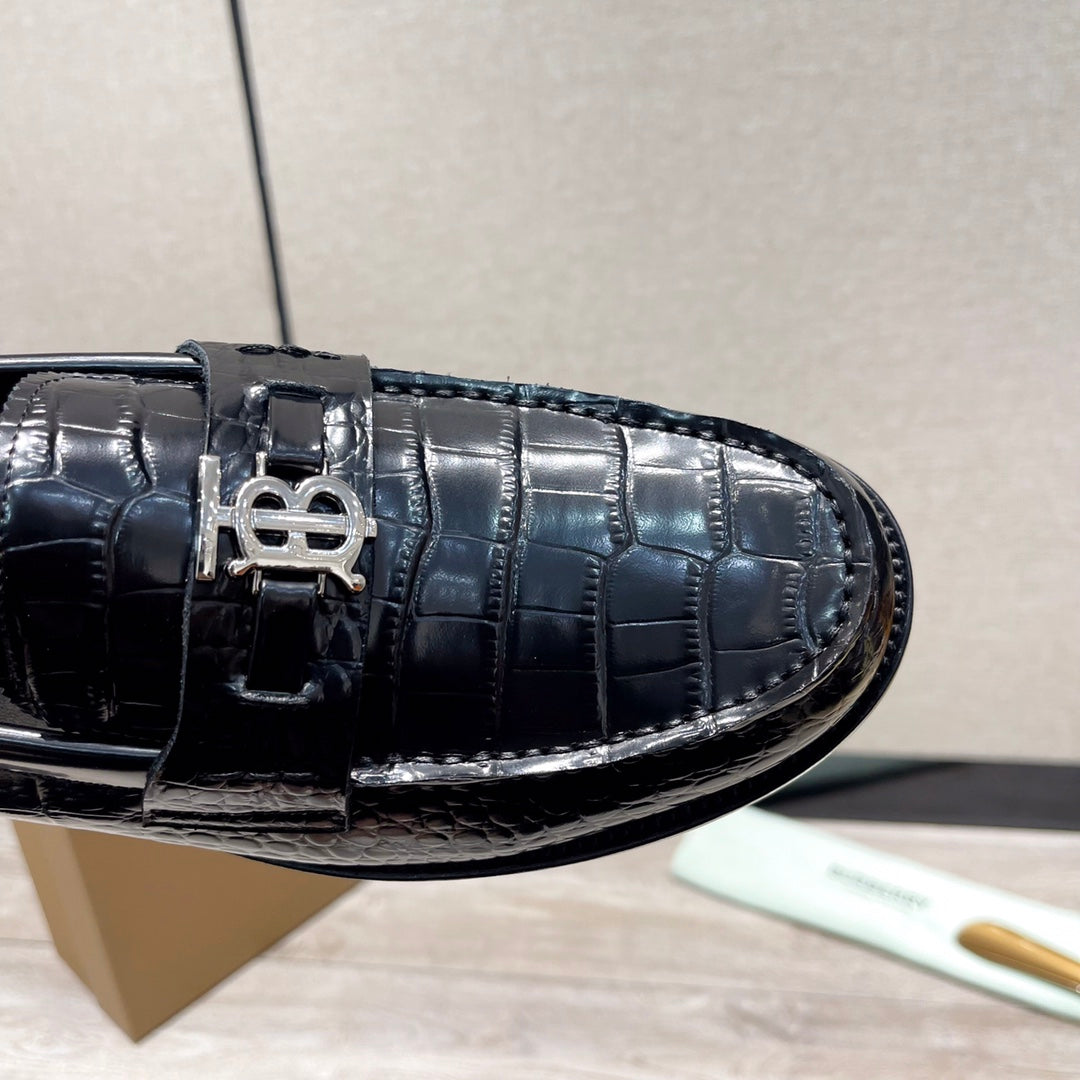 Black embossed leather loafer with metal buckle detail and stitch trim