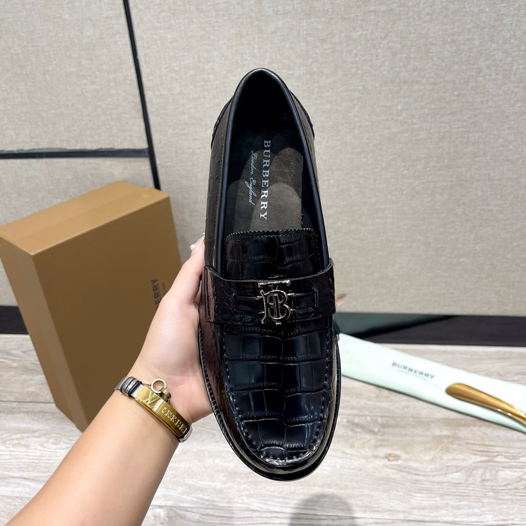 Black leather loafer with embossed upper and metal buckle strap