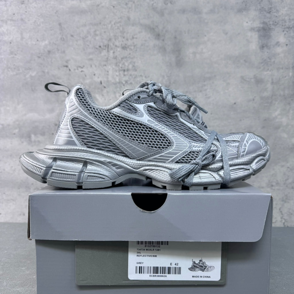 Balenciaga lace-up sneakers with light gray-blue mesh panels, shown on box