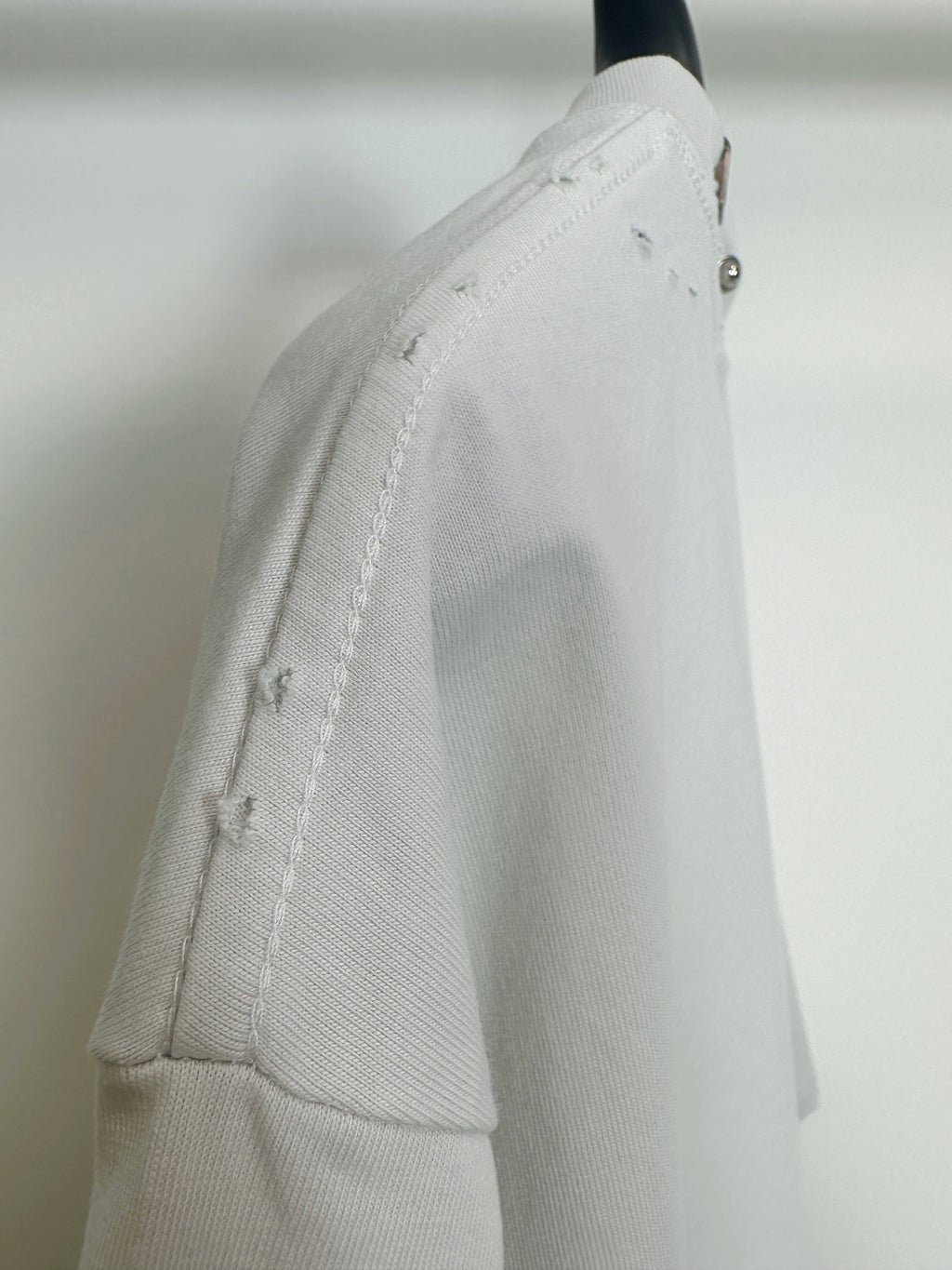 Balenciaga white short-sleeve T-shirt side view with distressed seam detail