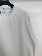 Balenciaga white short-sleeve T-shirt close-up of studded neckline and sleeve