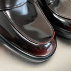 Prada unisex loafer toe detail, glossy black leather with burgundy edge and thick sole