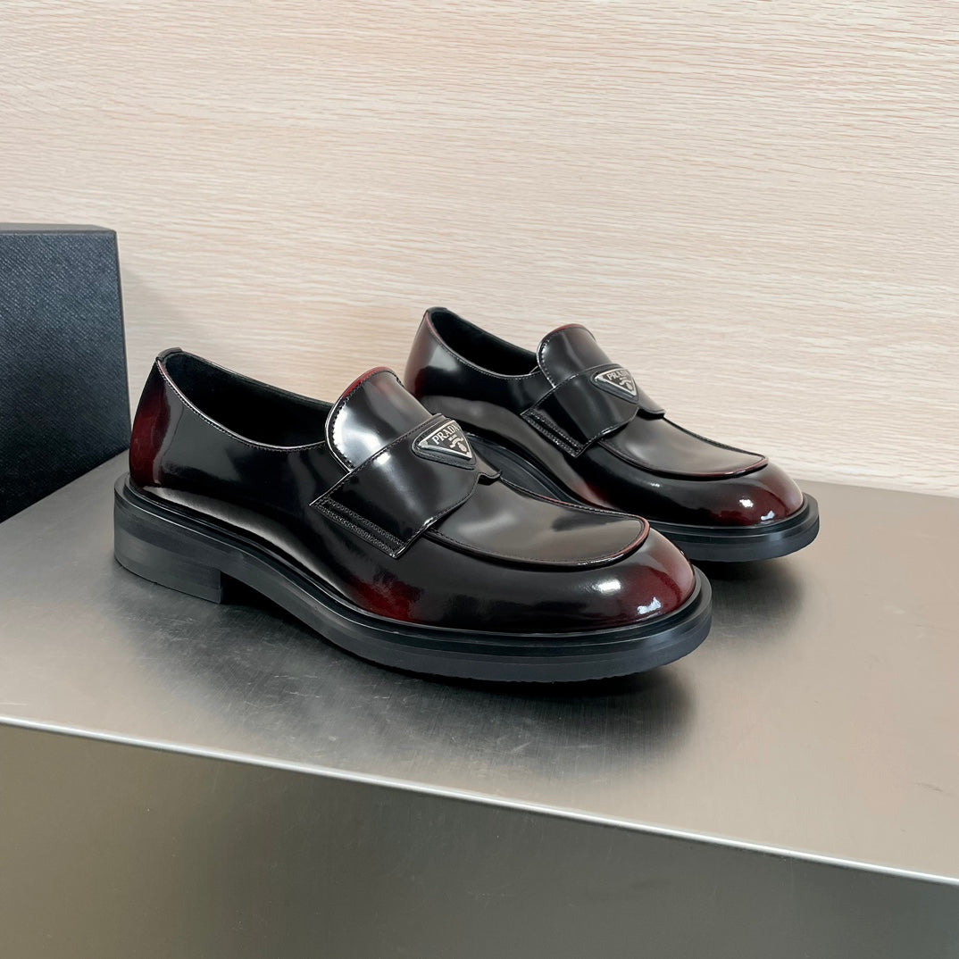 Prada unisex loafers, black leather with burgundy shine cap toe and metal logo badge