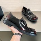 Prada unisex loafer shoe in hand, black leather slip-on with burgundy gloss toe