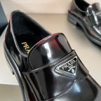 Prada unisex loafer upper close-up, black leather with stitched trim and logo badge