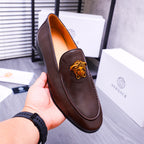 Brown leather slip-on loafer with gold Medusa emblem and pointed toe