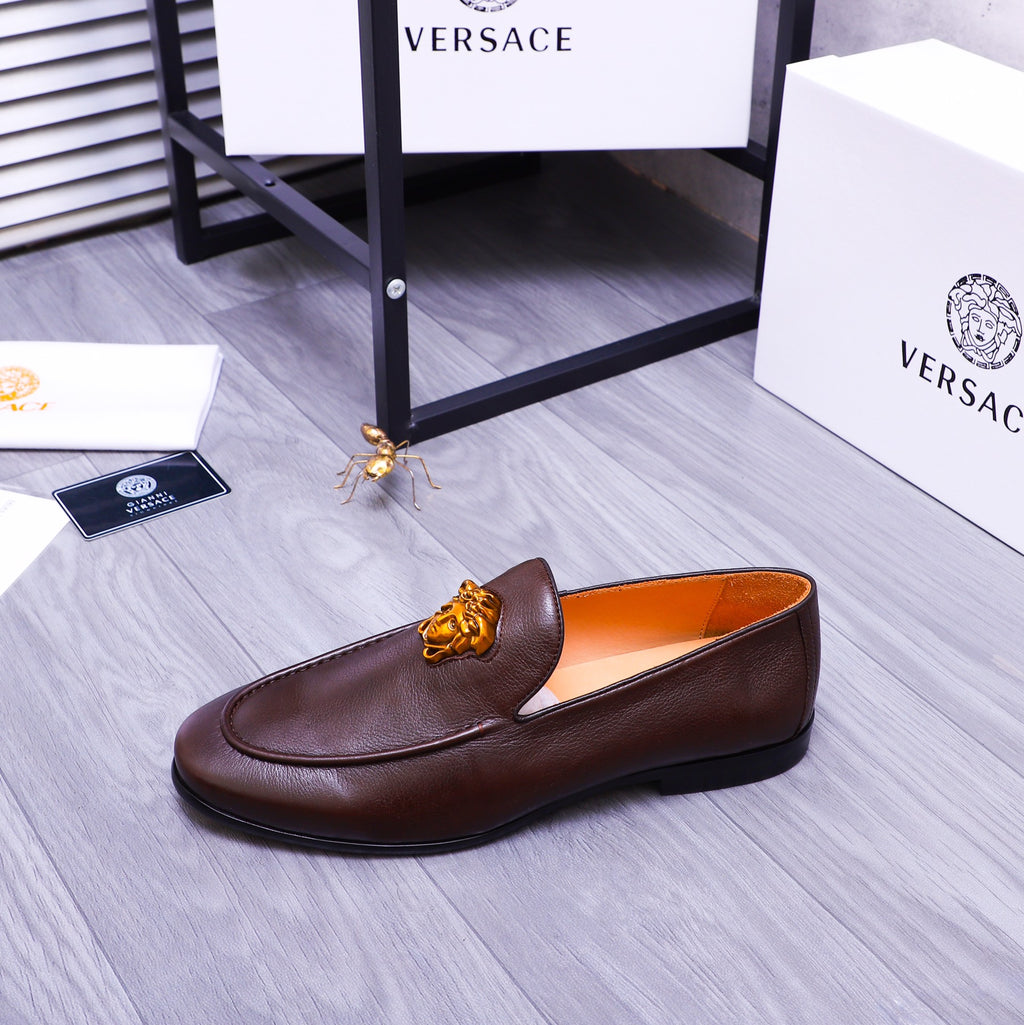 Brown leather slip-on loafer with gold Medusa emblem and moccasin seams