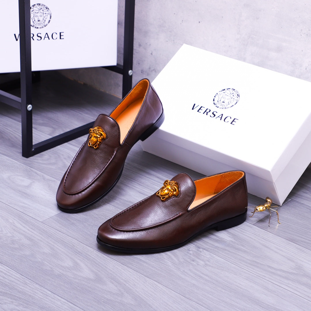 Pair of brown leather slip-on loafers with gold Medusa emblems