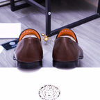 Back view of brown leather slip-on loafers with orange lining