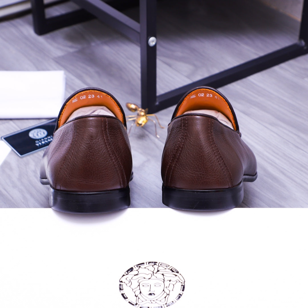 Back view of brown leather slip-on loafers with orange lining
