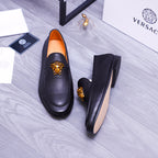 Versace black leather loafers with gold Medusa emblem and orange interior lining